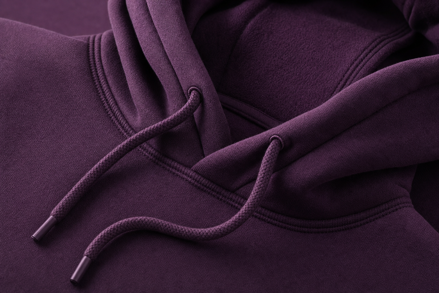 Close-up of a premium fleece hoodie showing the drawstring and stitching detail